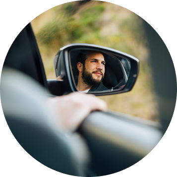 Chico mirando por el retrovisor de un coche